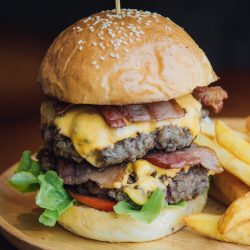 Double Traditional Burger2X200 gr. Dry aged beef, bacon, caramelized onions, tomatoes, and lettuce. Double Traditional Burger 2X200 gr. Dry aged beef, bacon, caramelized onions, tomatoes, and lettuce.