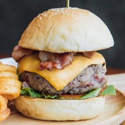 Traditional Burger200 gr. Dry aged beef, bacon, caramelized onions, tomatoes, and lettuce. Traditional Burger 200 gr. Dry aged beef, bacon, caramelized onions, tomatoes, and lettuce.